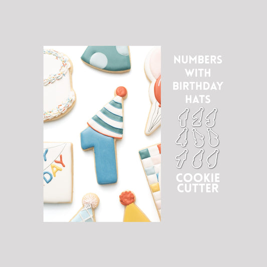 Decorated numbers with birthday hat sugar cookie next to a numbers with birthday hat cookie cutter outline on a gray background.