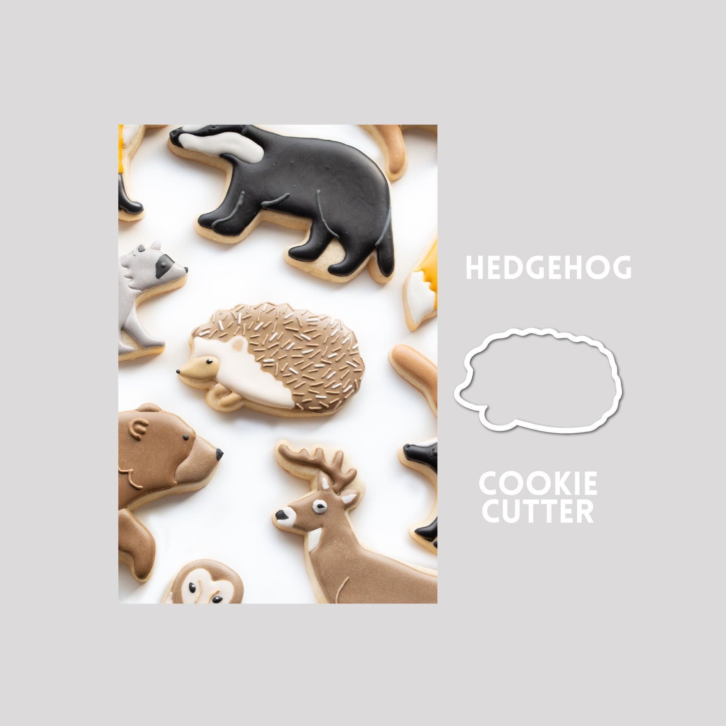 Decorated hedgehog sugar cookie next to a hedgehog cookie cutter outline on a gray background.