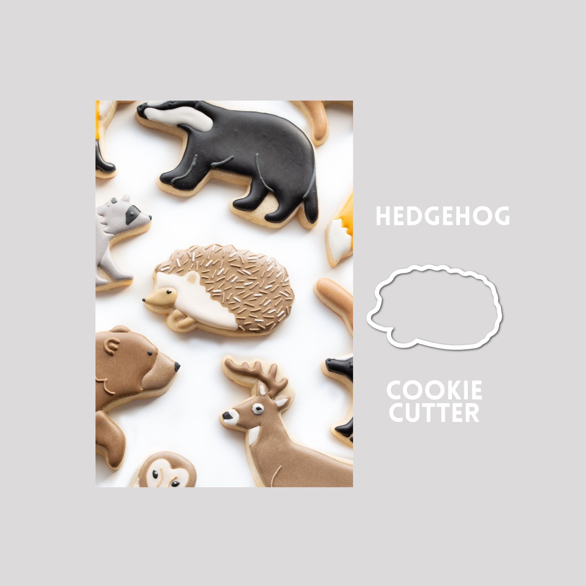 Decorated hedgehog sugar cookie next to a hedgehog cookie cutter outline on a gray background.