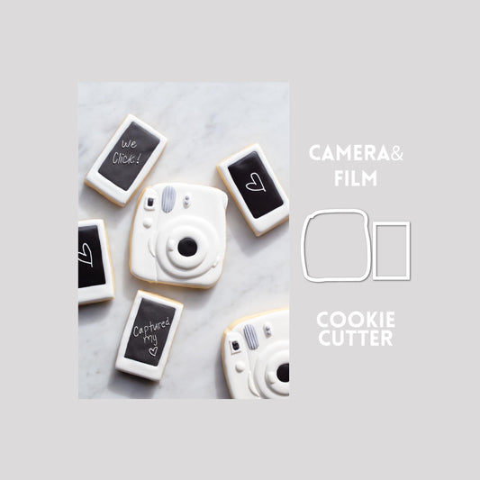 Decorated camera and film sugar cookie next to a camera and film cookie cutter outline on a gray background.