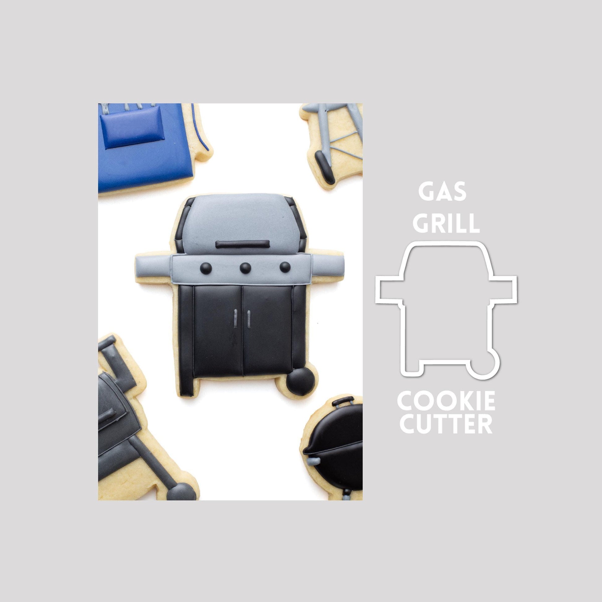 Decorated gas grill sugar cookie next to a gas grill cookie cutter outline on a gray background.