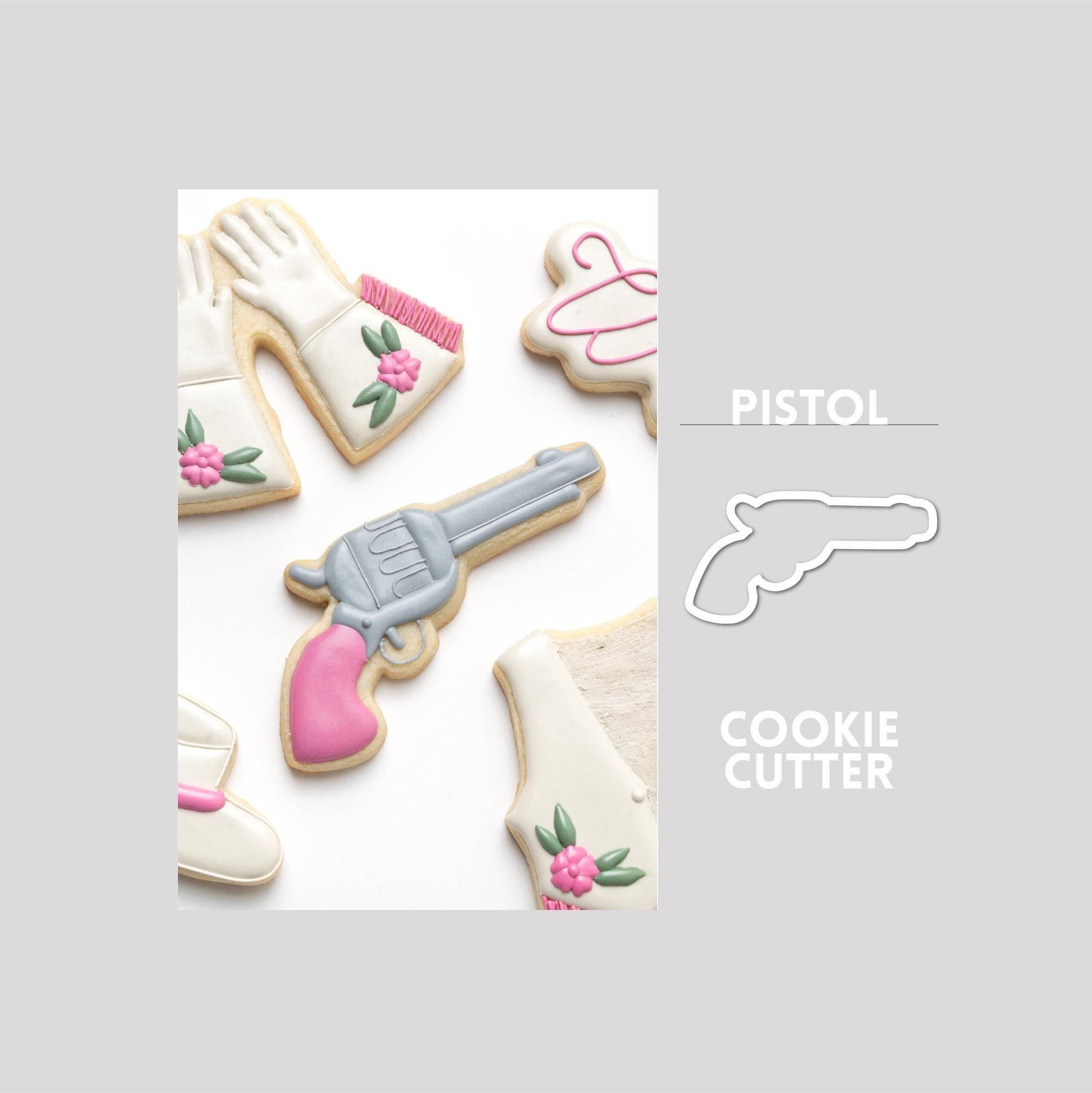 Decorated pistol sugar cookie next to a pistol cookie cutter outline on a gray background.