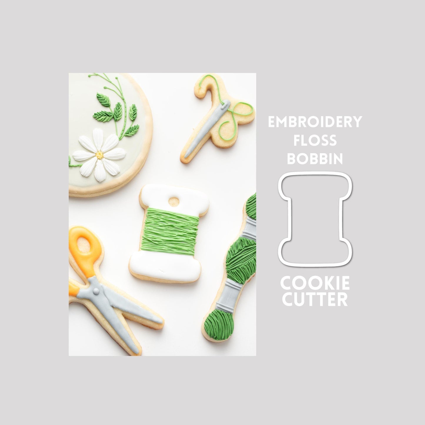 Decorated embroidery floss sugar cookie next to a embroidery floss cookie cutter outline on a gray background.
