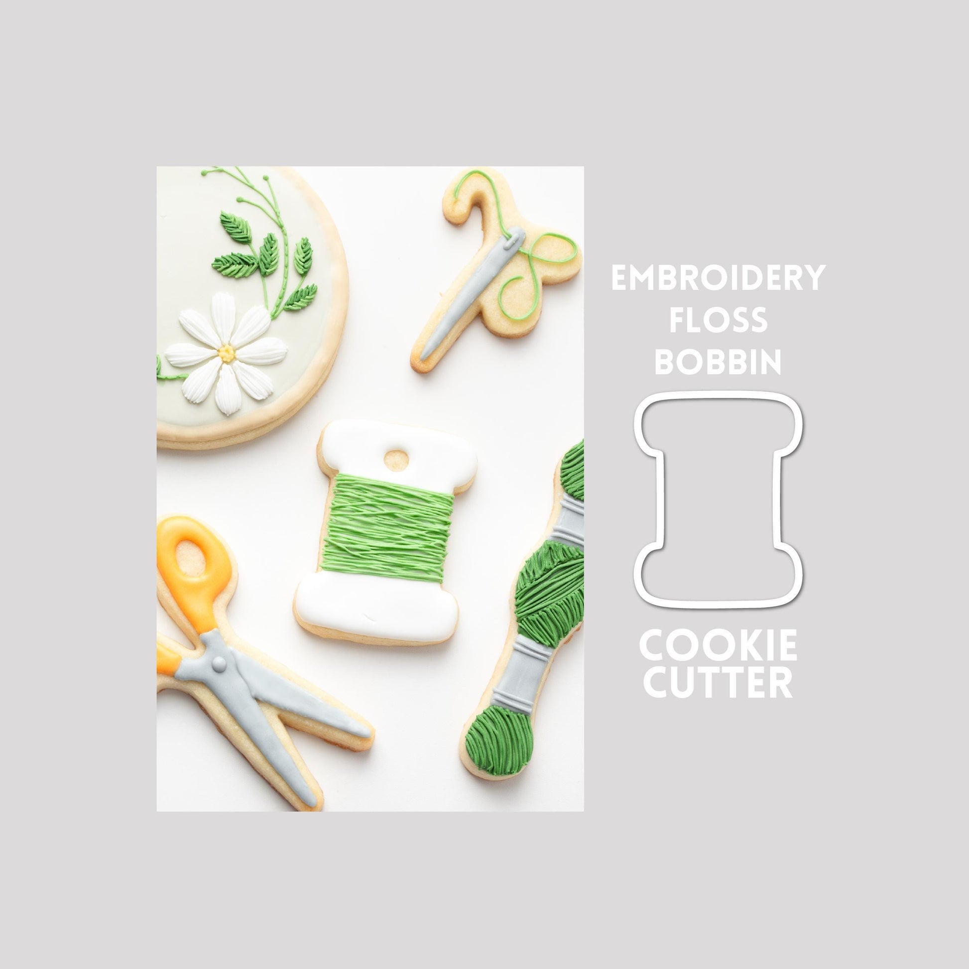 Decorated embroidery floss sugar cookie next to a embroidery floss cookie cutter outline on a gray background.