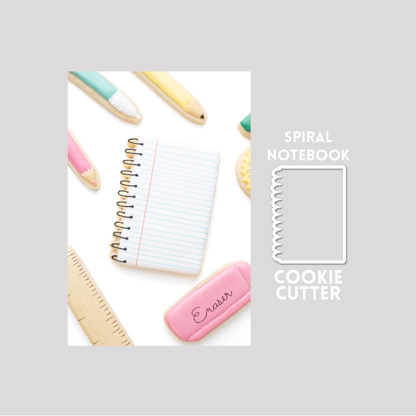 Decorated spiral notebook sugar cookie next to a spiral notebook cookie cutter outline on a gray background.