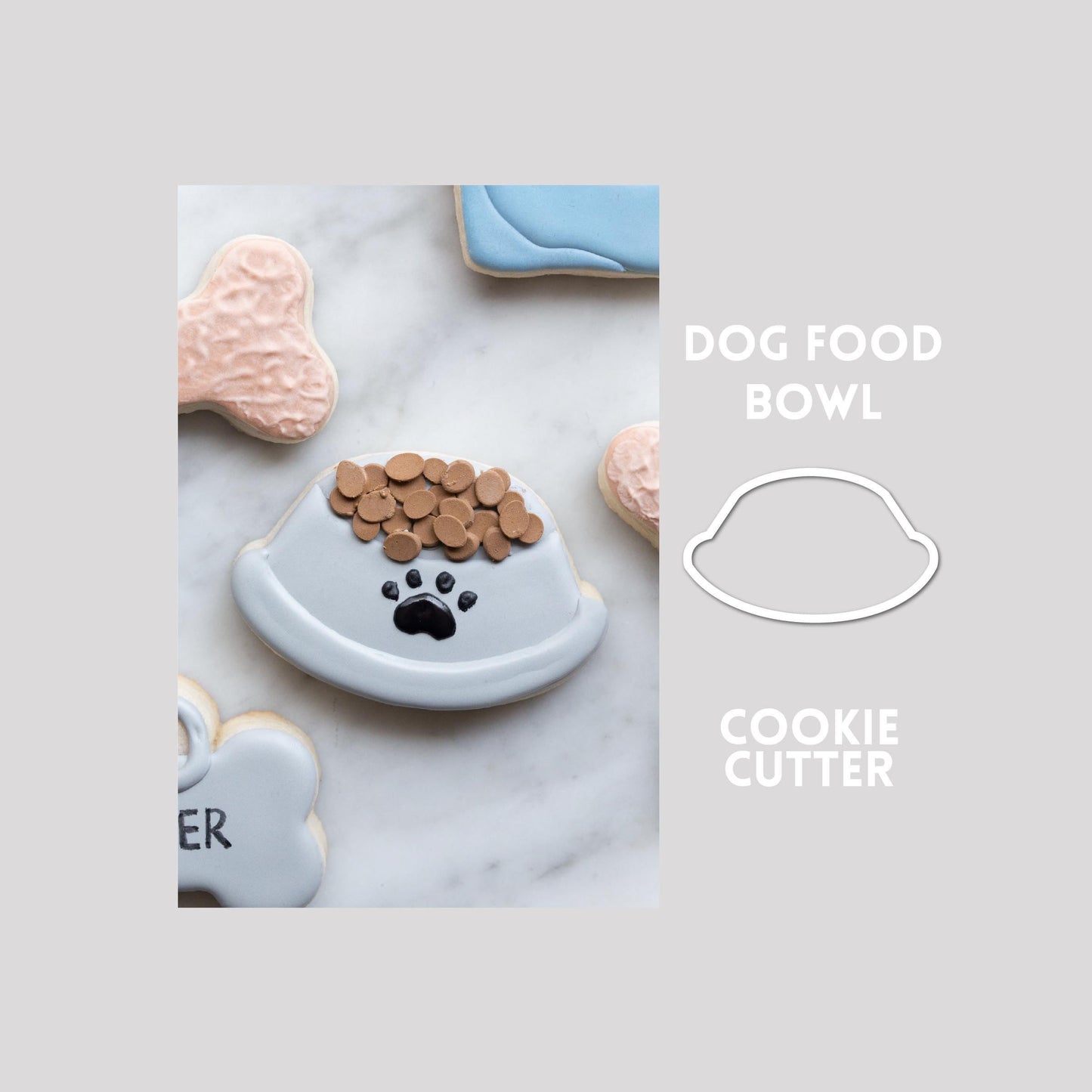Decorated dog food bowl sugar cookie next to a dog food bowl cookie cutter outline on a gray background.