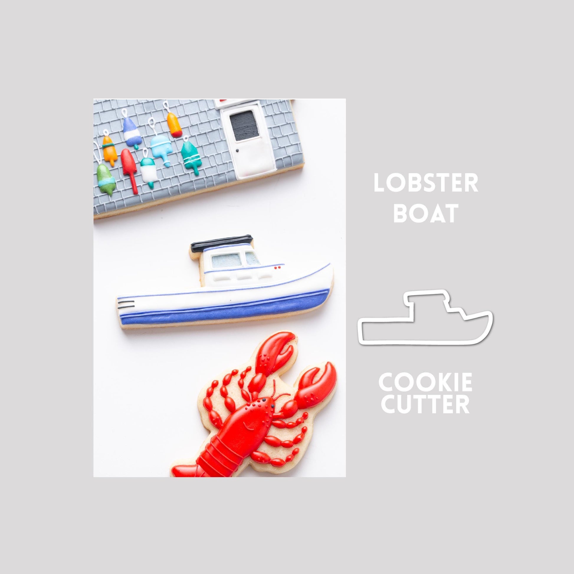 Decorated lobster sugar cookie next to a lobster cookie cutter outline on a gray background.