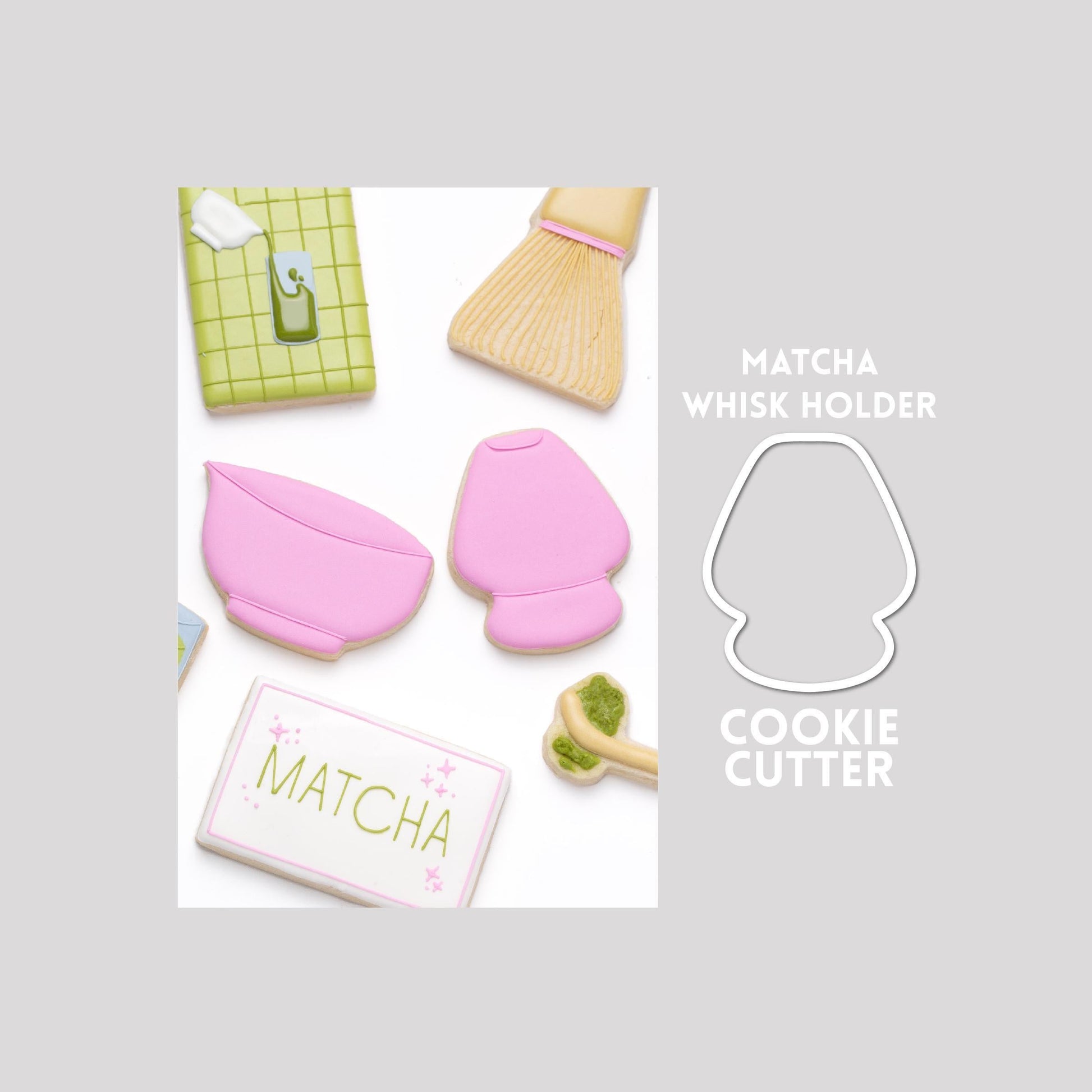 Decorated matcha whisk sugar cookie next to a matcha whisk cookie cutter outline on a gray background.