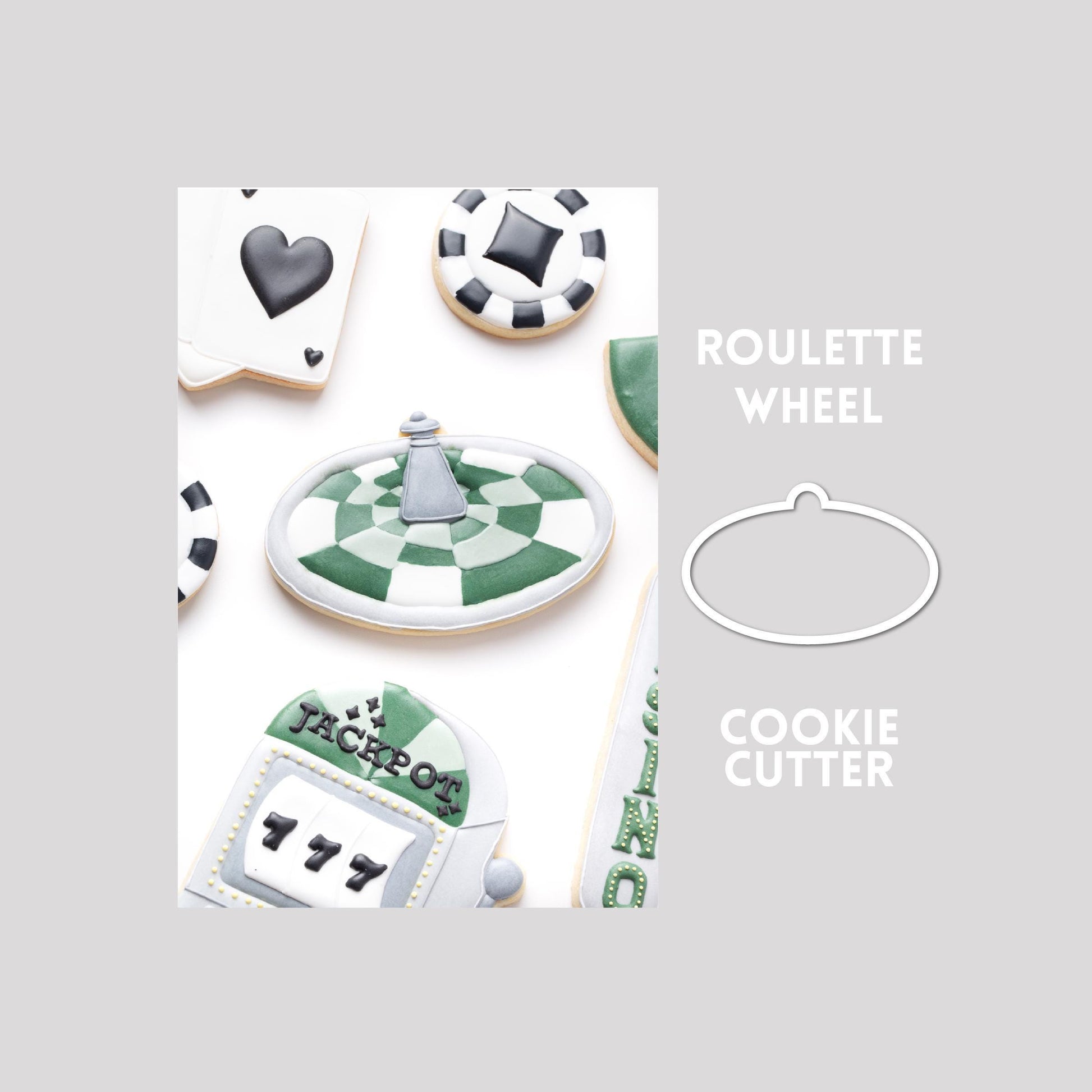 Decorated roulette wheel sugar cookie next to a roulette wheel cookie cutter outline on a gray background.
