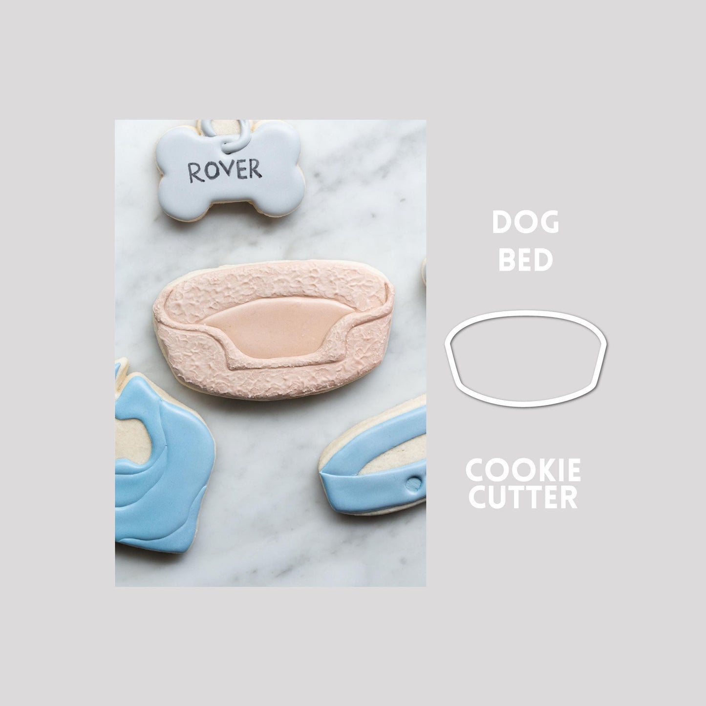 Decorated dog bed sugar cookie next to a dog bed cookie cutter outline on a gray background.