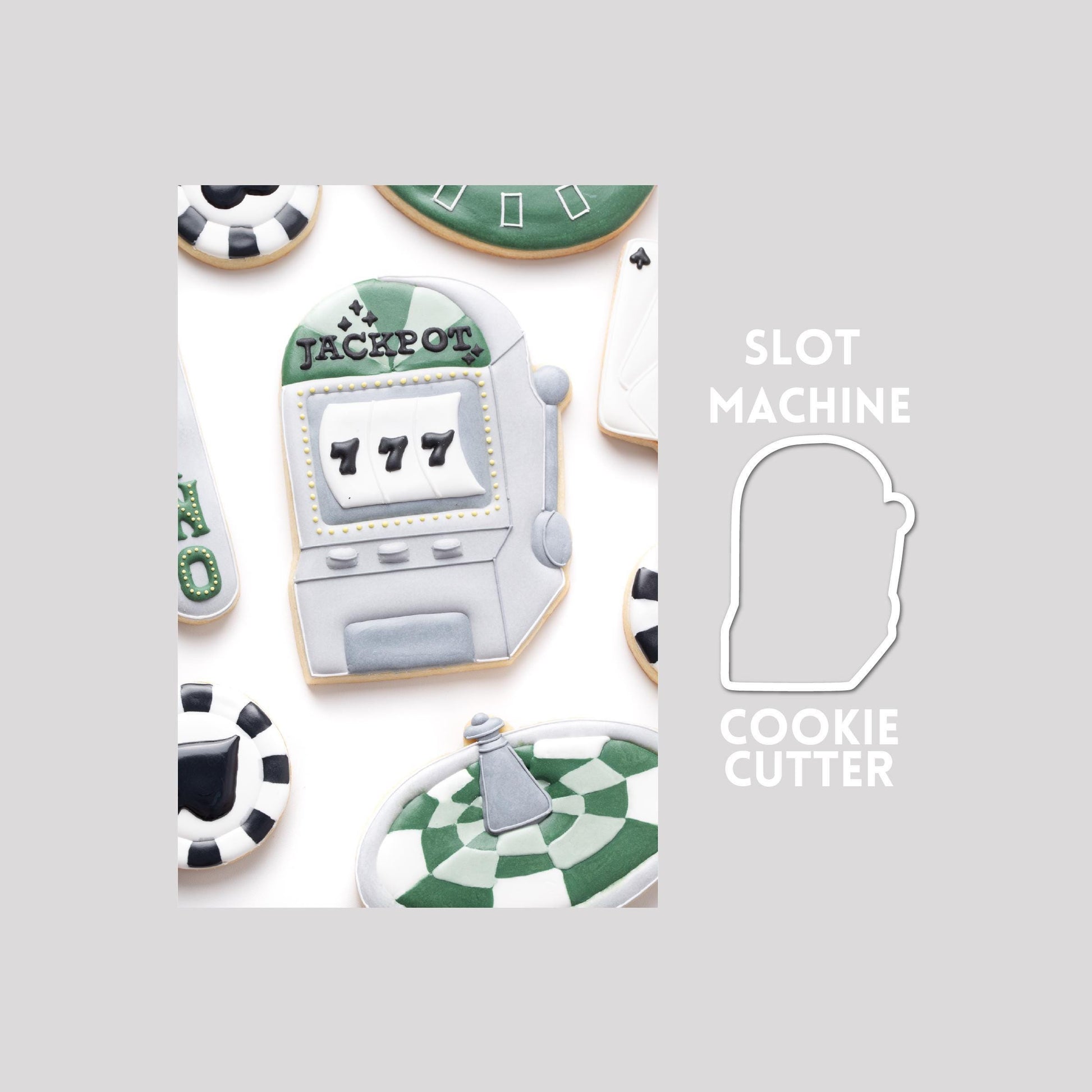Decorated slot machine sugar cookie next to a slot machine cookie cutter outline on a gray background.