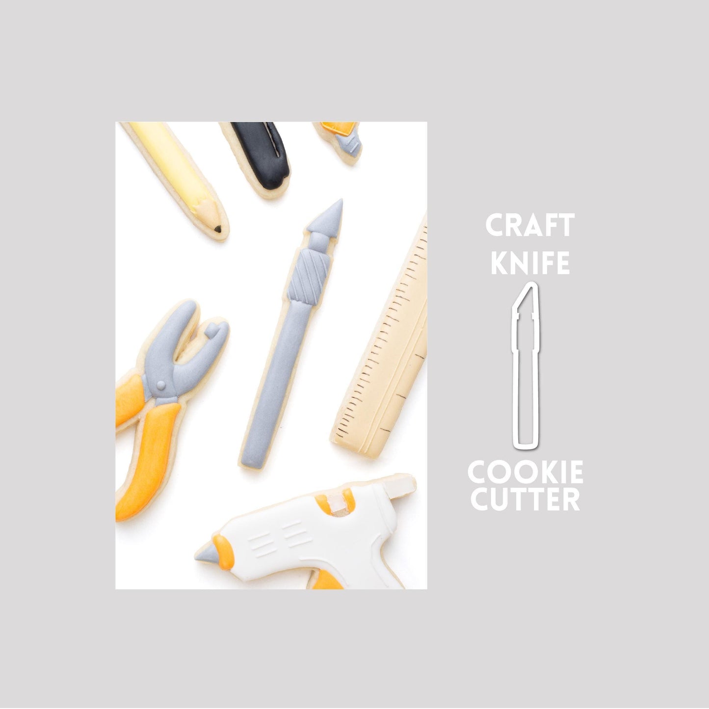 Decorated craft knife sugar cookie next to a craft knife cookie cutter outline on a gray background.