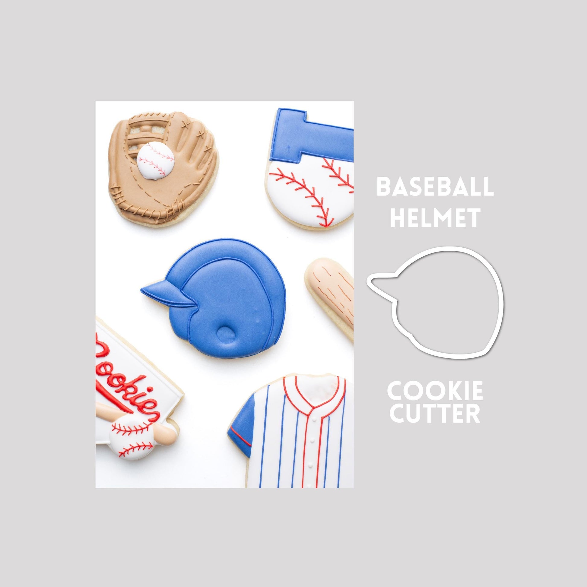 Decorated baseball helmet sugar cookie next to a baseball helmet cookie cutter outline on a gray background.