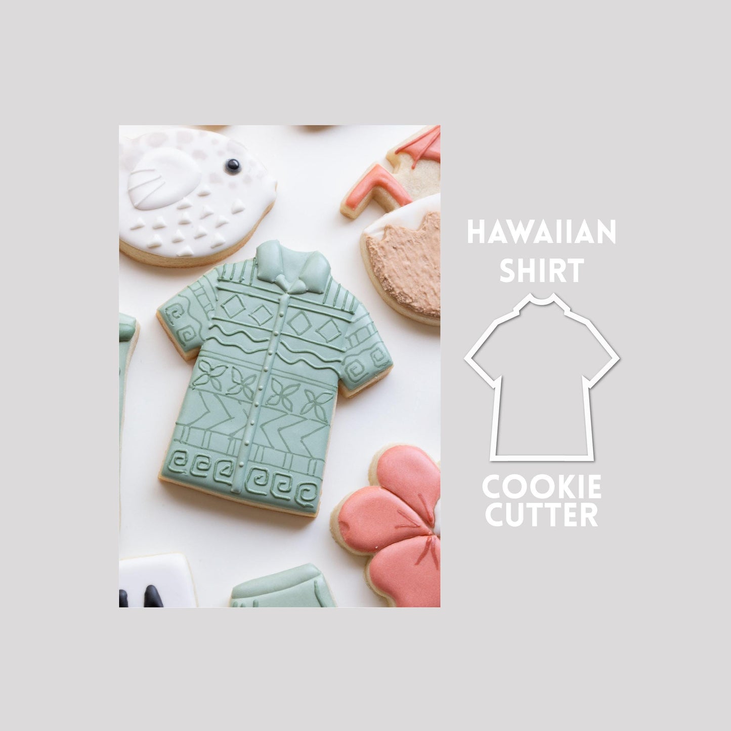 Decorated Hawaiian shirt sugar cookie next to a Hawaiian shirt cookie cutter outline on a gray background.