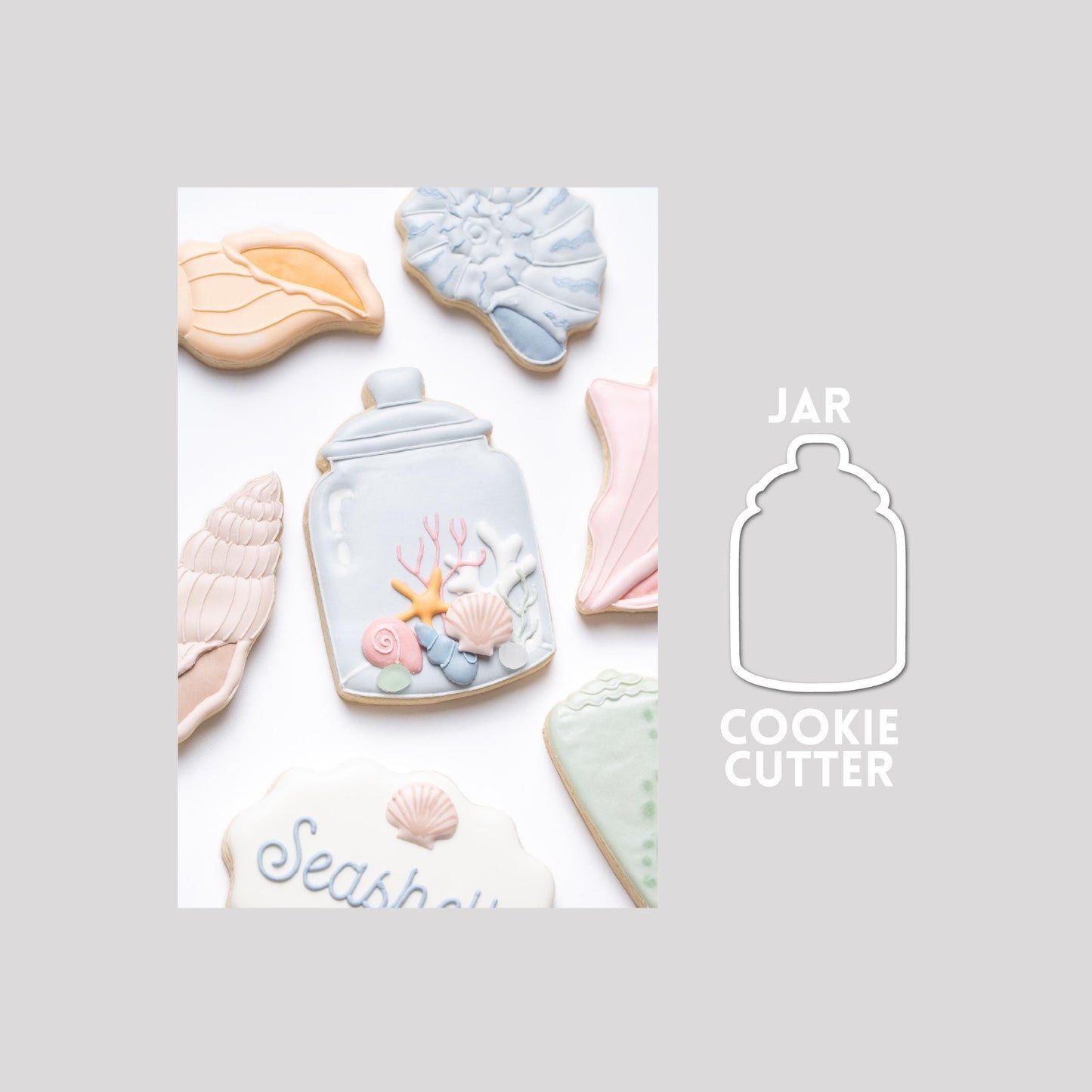 Decorated jar sugar cookie next to a jar cookie cutter outline on a gray background.