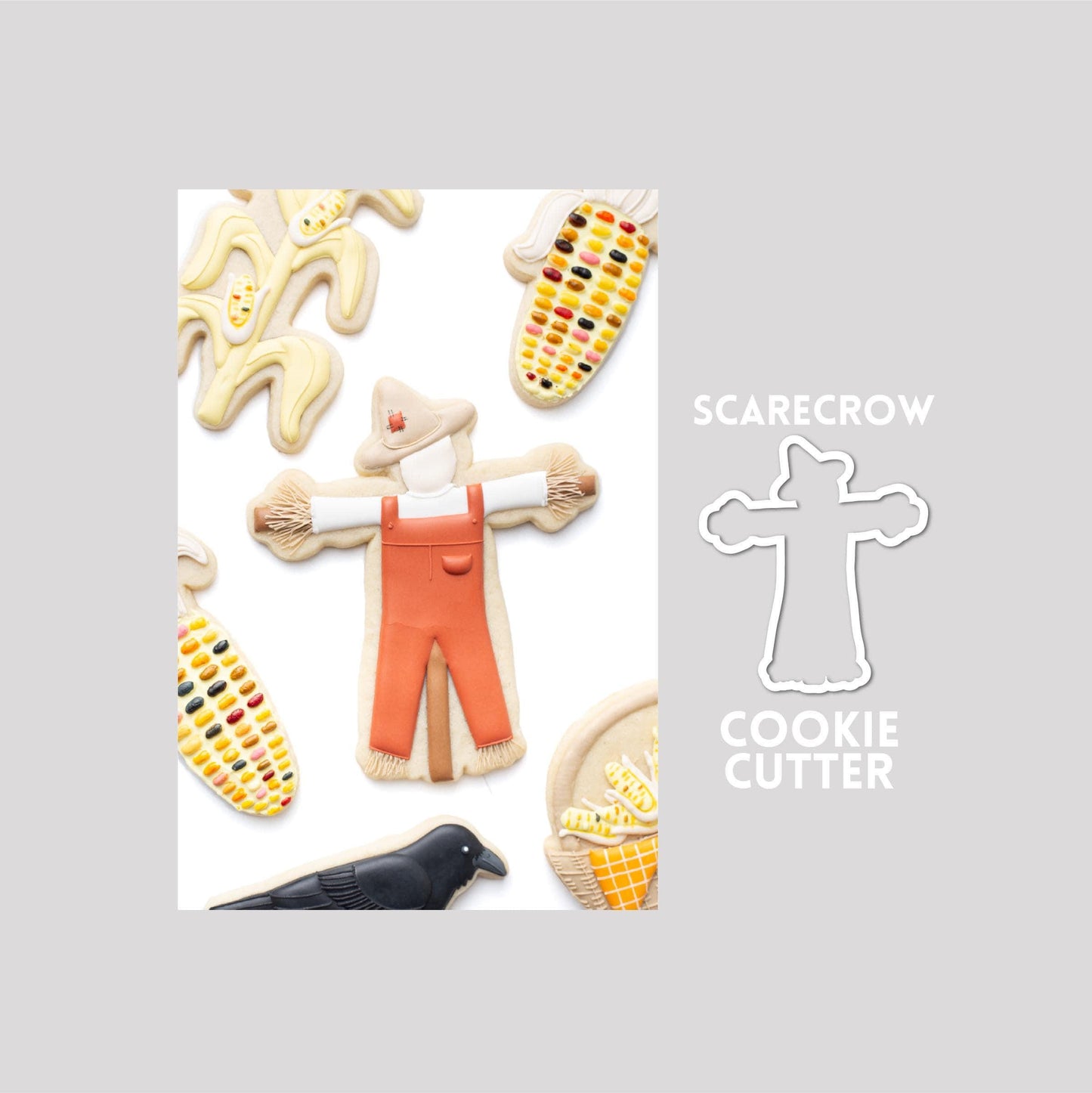 Decorated scarecrow sugar cookie next to a scarecrow cookie cutter outline on a gray background.