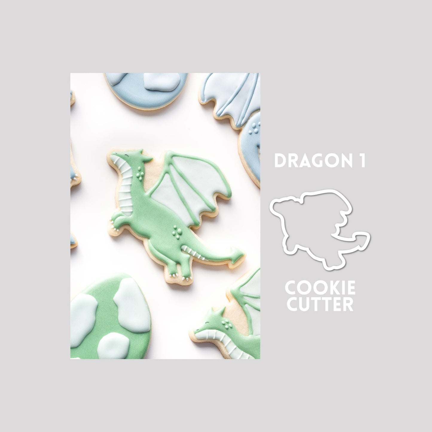 Decorated dragon sugar cookie next to a dragon cookie cutter outline on a gray background.