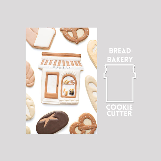 Decorated bread bakery sugar cookie next to a bread bakery cookie cutter outline on a gray background.