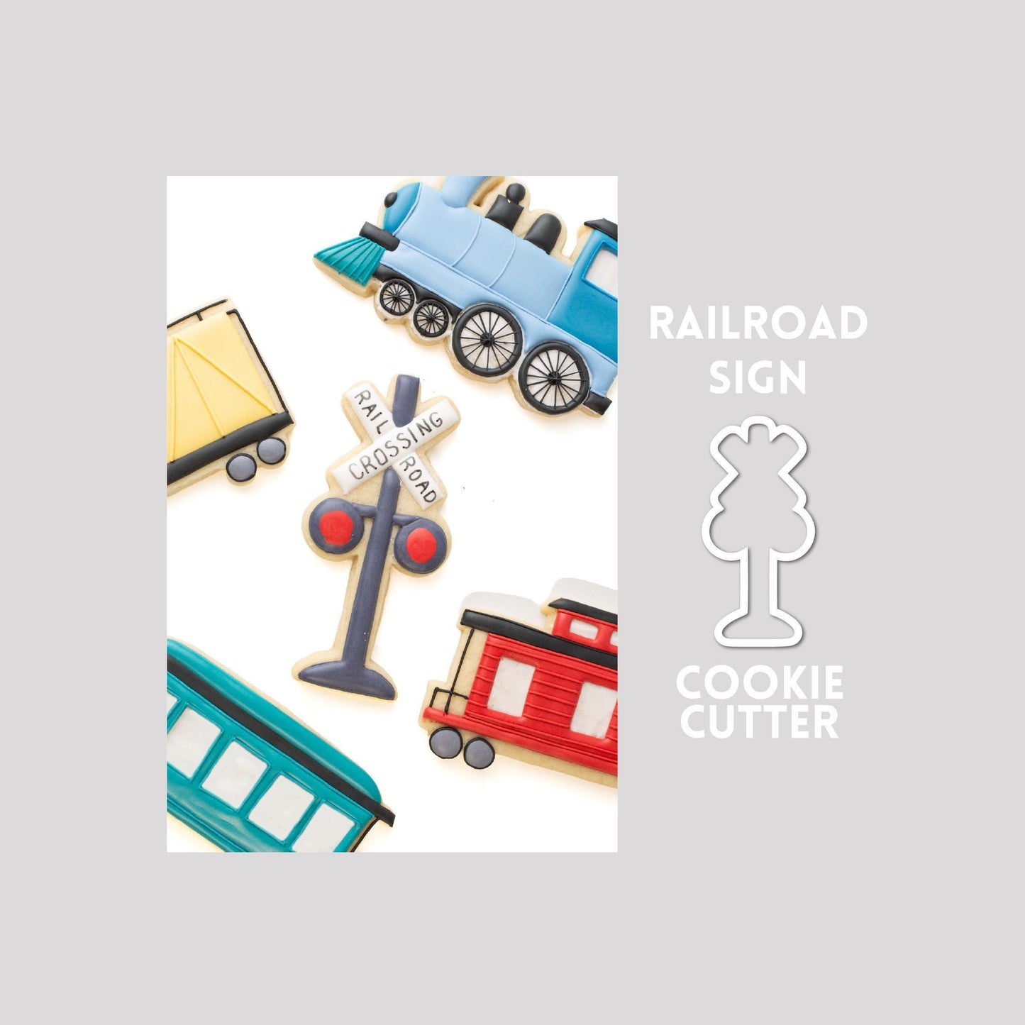 Decorated railroad sign sugar cookie next to a railroad sign cookie cutter outline on a gray background.