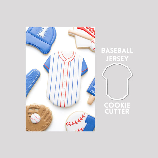 Decorated baseball jersey sugar cookie next to a baseball jersey cookie cutter outline on a gray background.