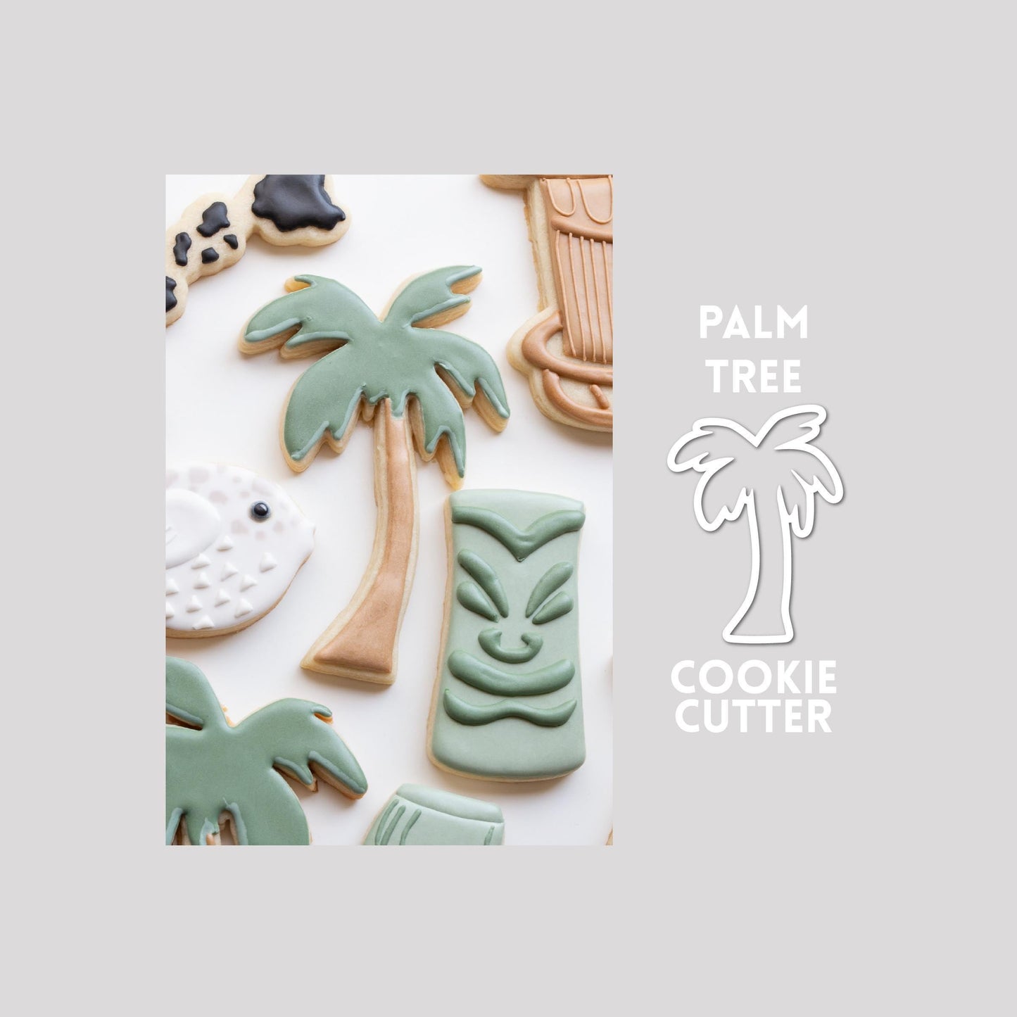 Decorated palm tree sugar cookie next to a palm tree cookie cutter outline on a gray background.