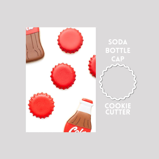 Decorated soda bottle sugar cookie next to a soda bottle cookie cutter outline on a gray background.