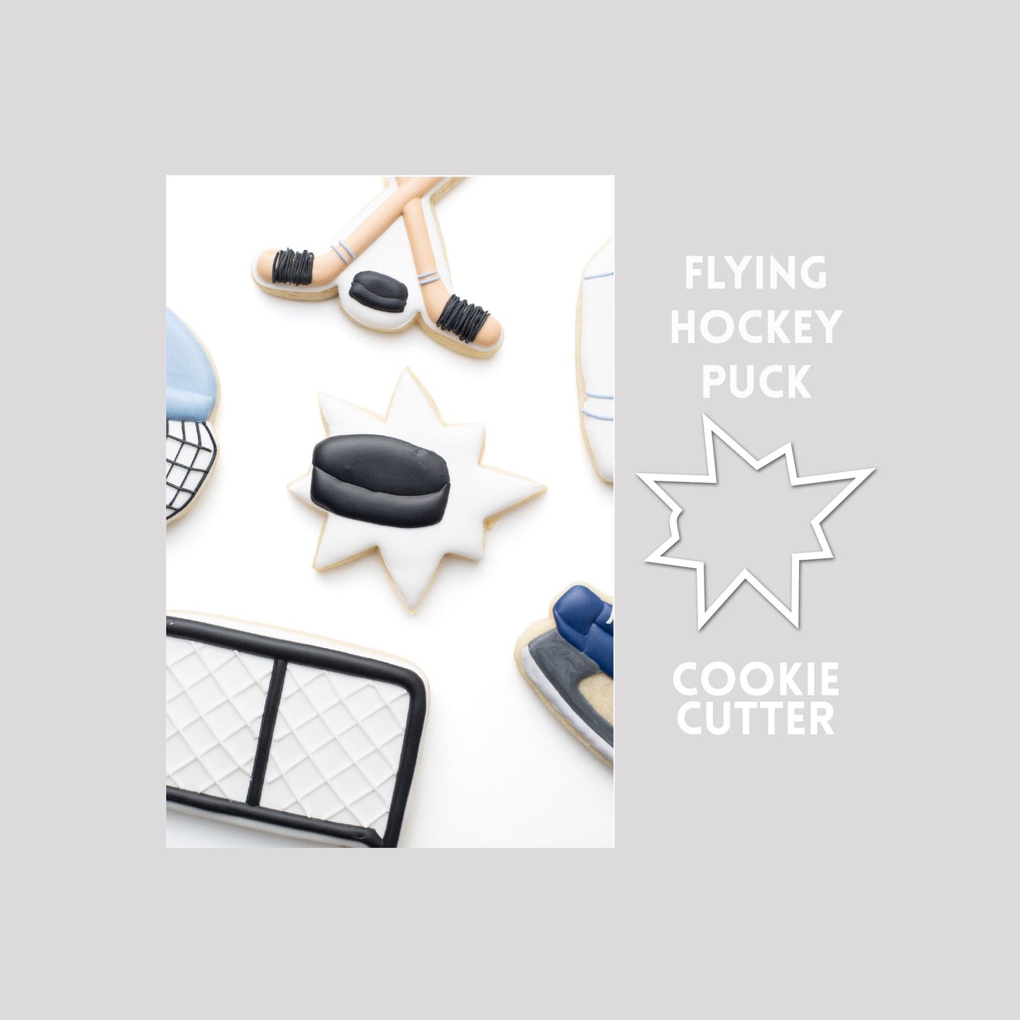 Decorated flying hockey puck sugar cookie next to a flying hockey puck cookie cutter outline on a gray background.