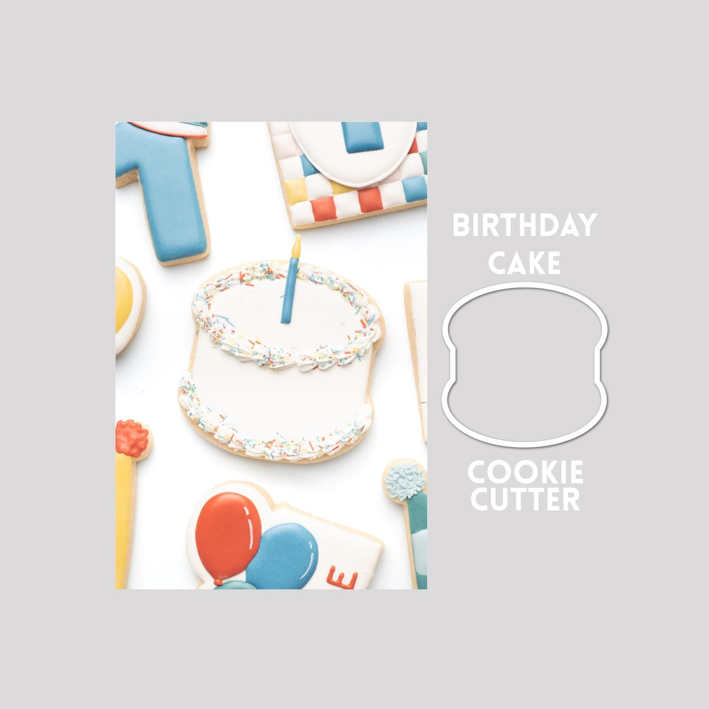 Decorated birthday cake sugar cookie next to a birthday cake cookie cutter outline on a gray background.