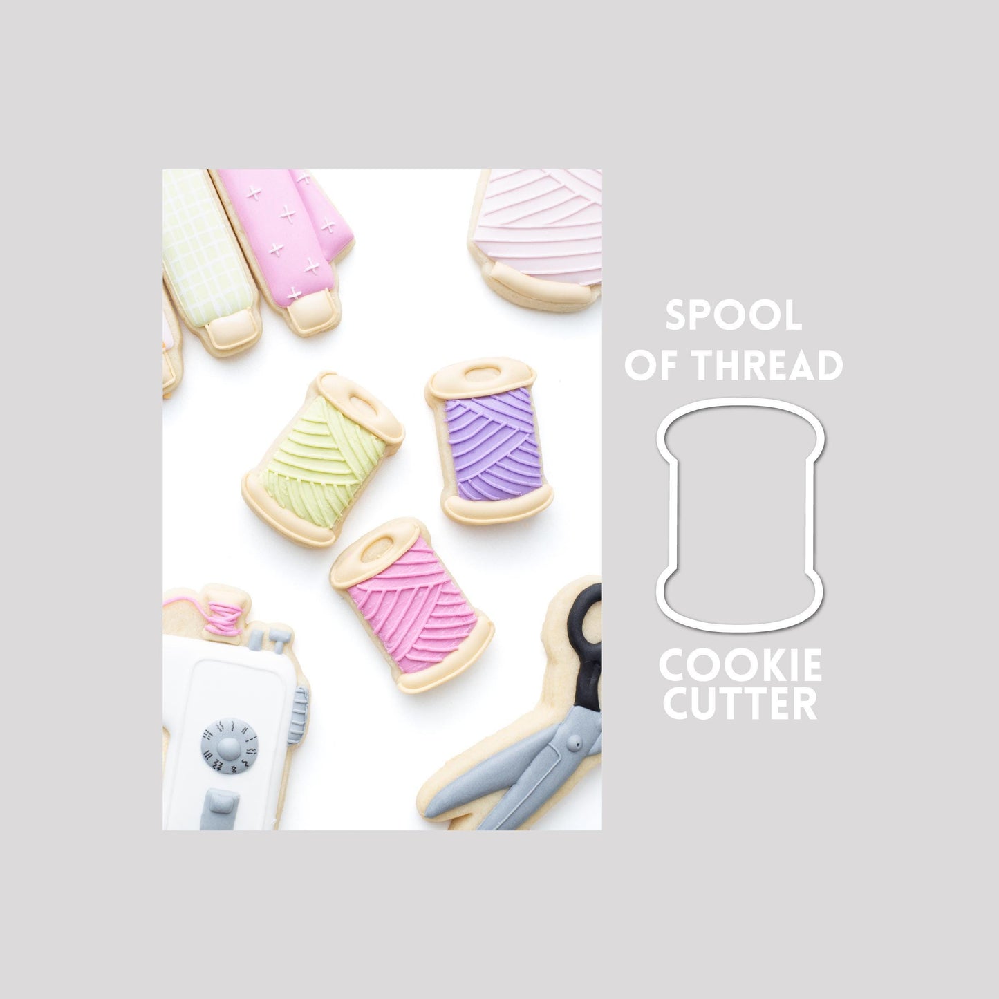 Decorated spool of thread sugar cookie next to a spool of thread cookie cutter outline on a gray background.