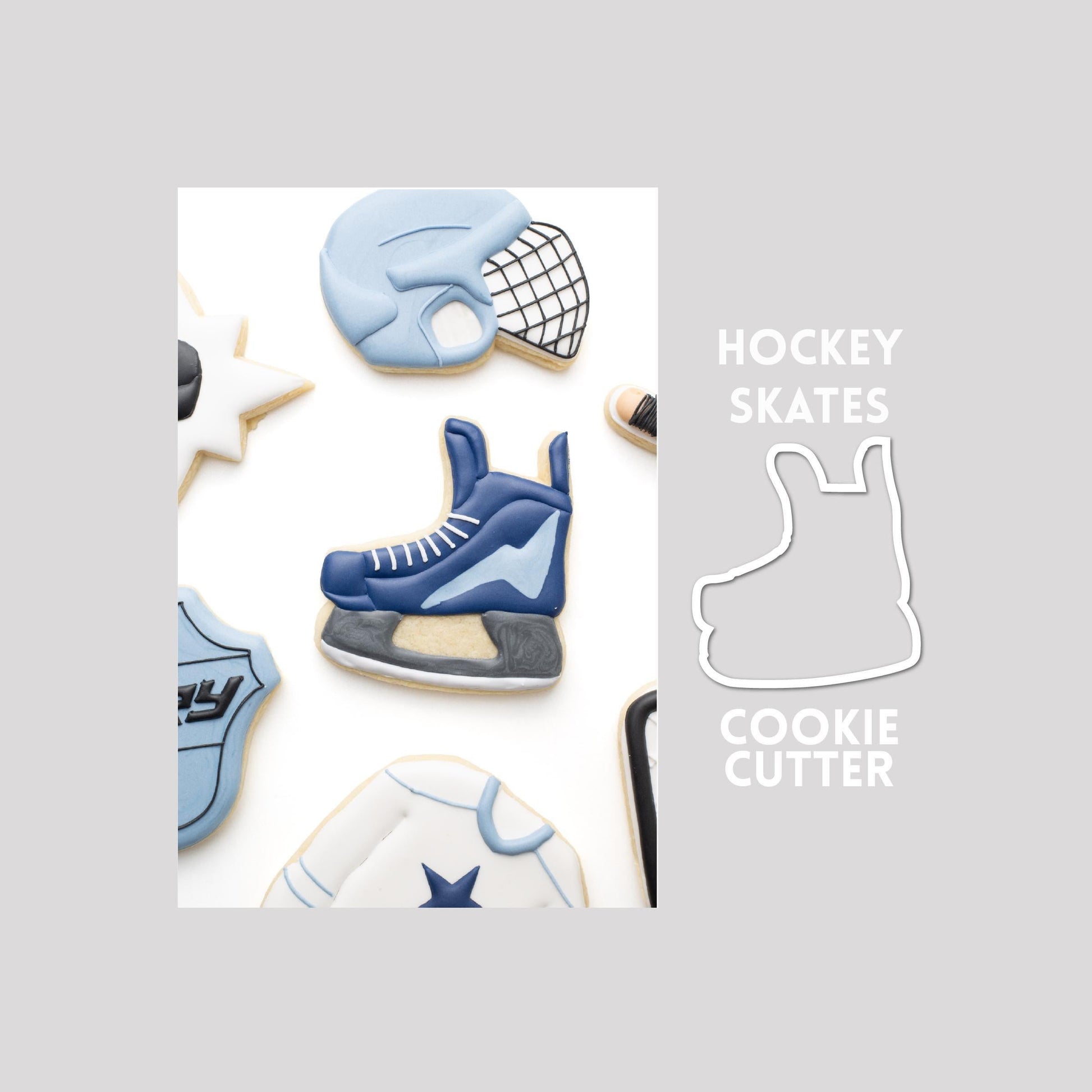 Decorated hockey skates sugar cookie next to a hockey skates cookie cutter outline on a gray background.