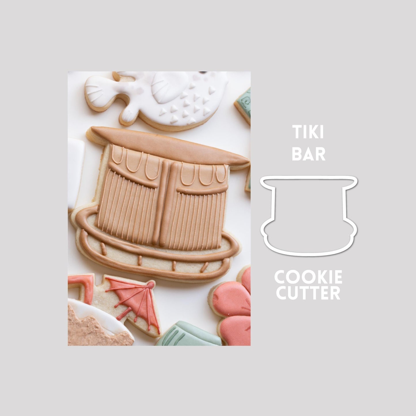Decorated tiki bar sugar cookie next to a tiki bar cookie cutter outline on a gray background.