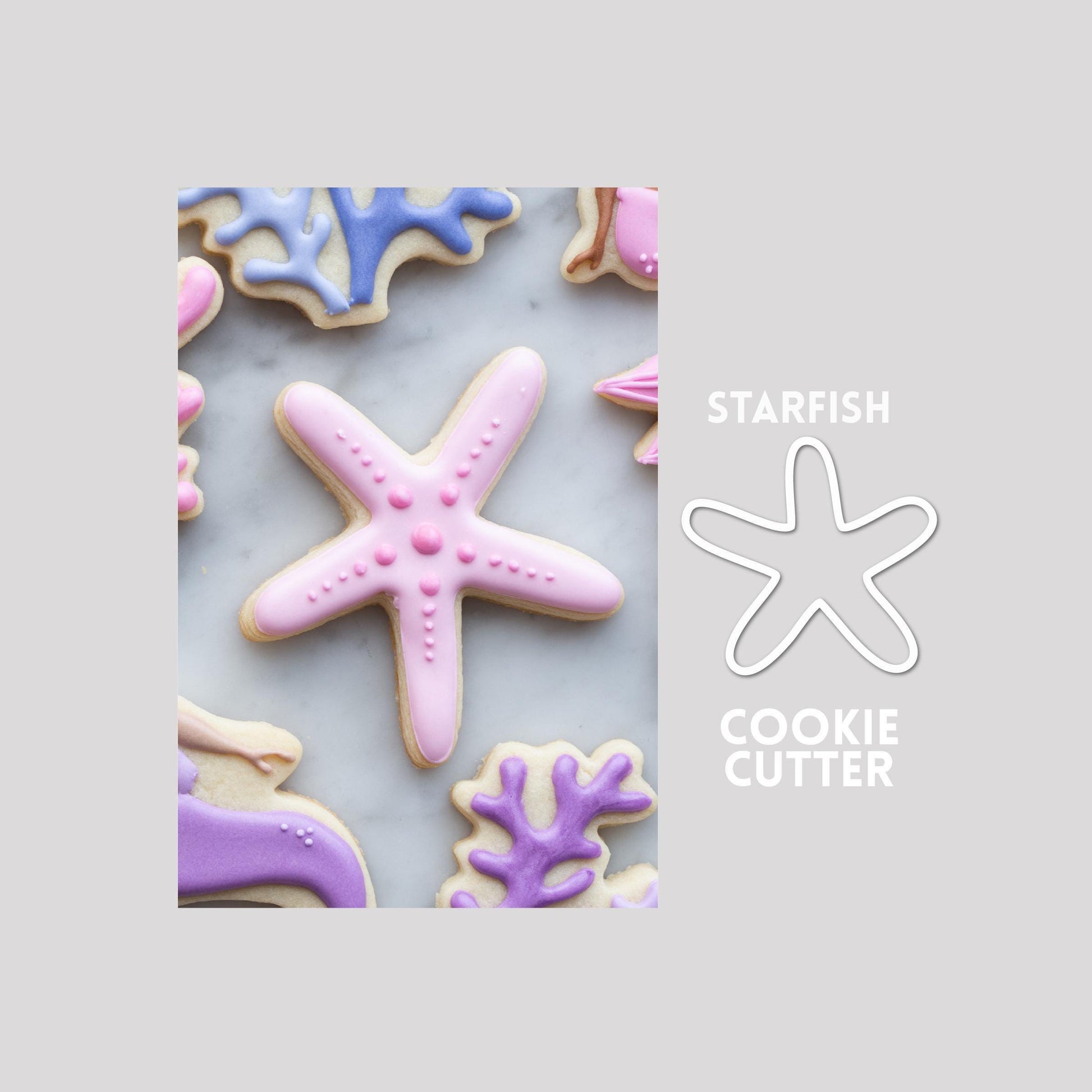 Decorated starfish sugar cookie next to a starfish cookie cutter outline on a gray background.
