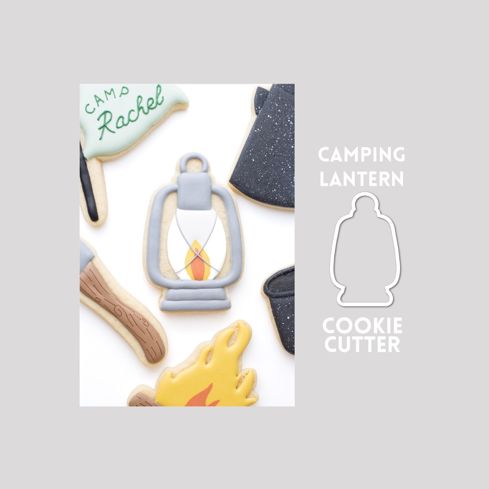 Decorated lantern sugar cookie next to a lantern cookie cutter outline on a gray background.