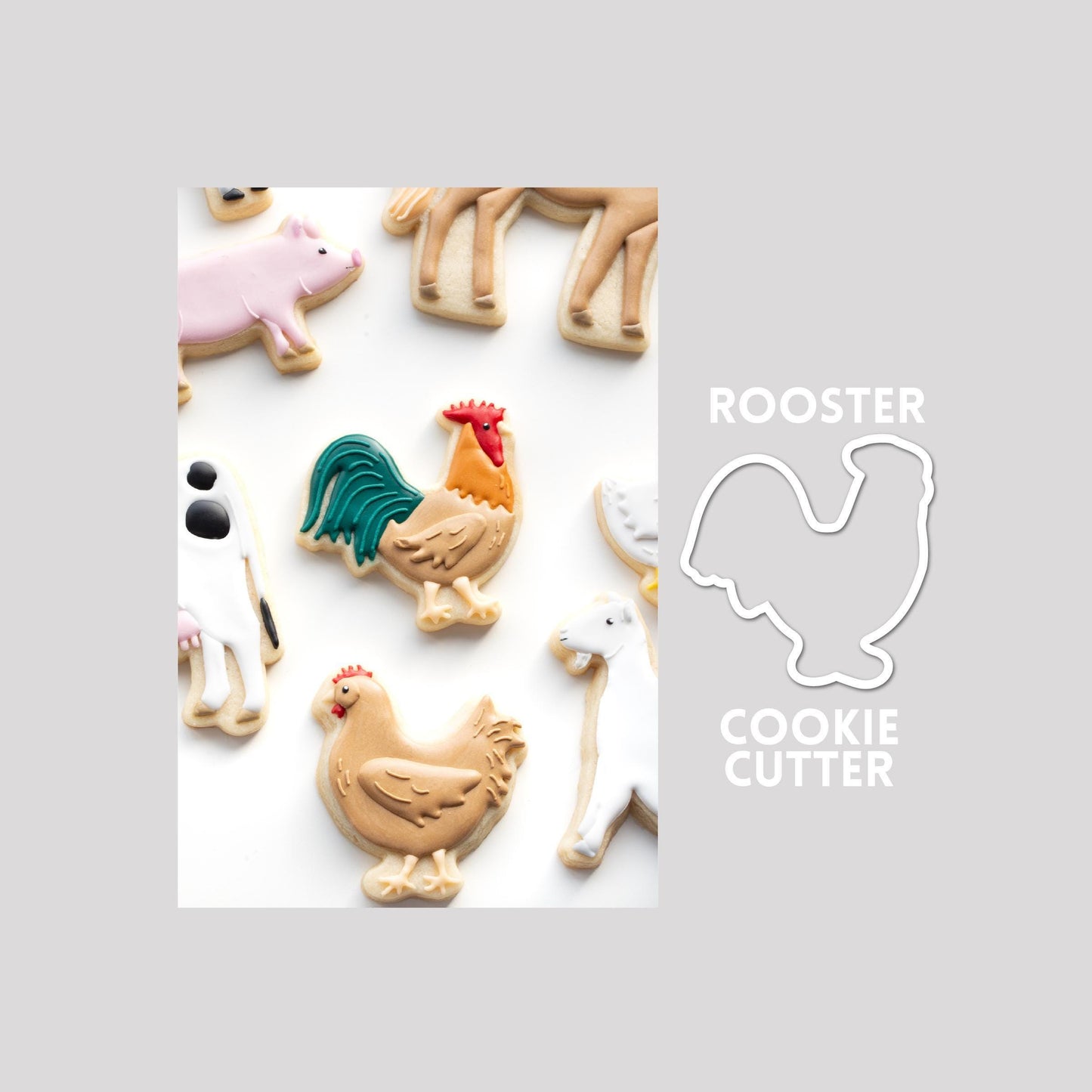 Decorated rooster sugar cookie next to a rooster cookie cutter outline on a gray background.