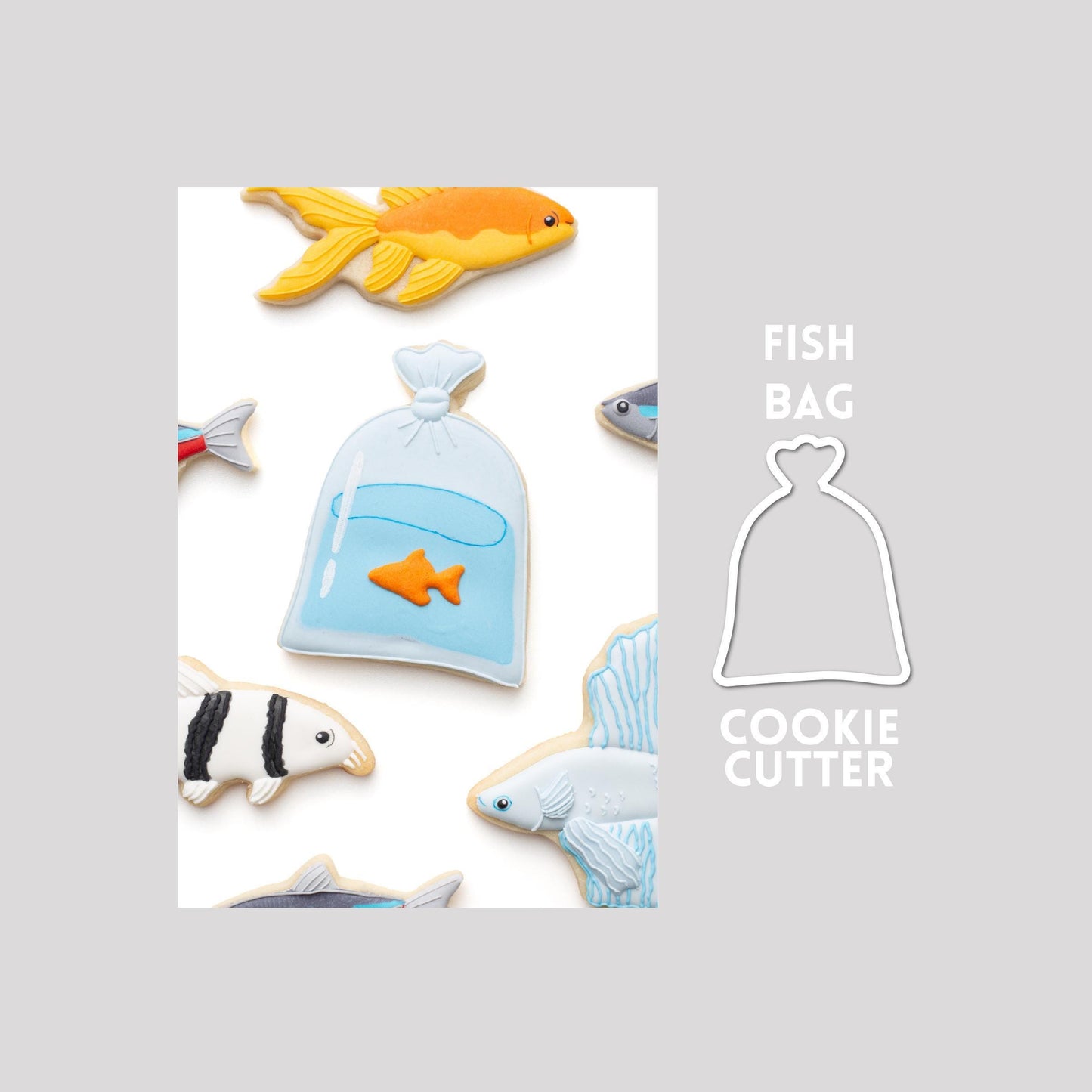 Decorated fish bag sugar cookie next to a fish bag cookie cutter outline on a gray background.