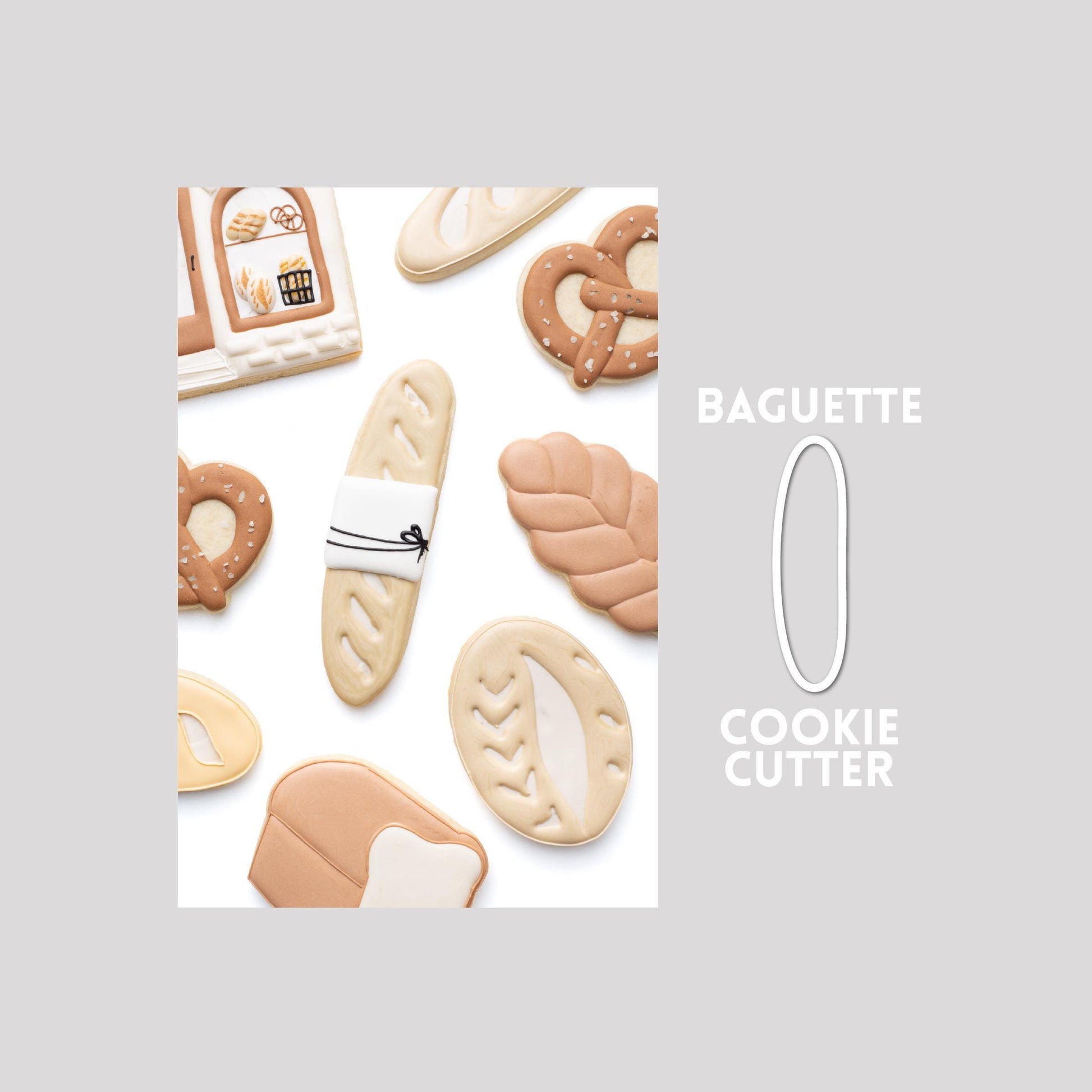 Decorated baguette sugar cookie next to a baguette cookie cutter outline on a gray background.