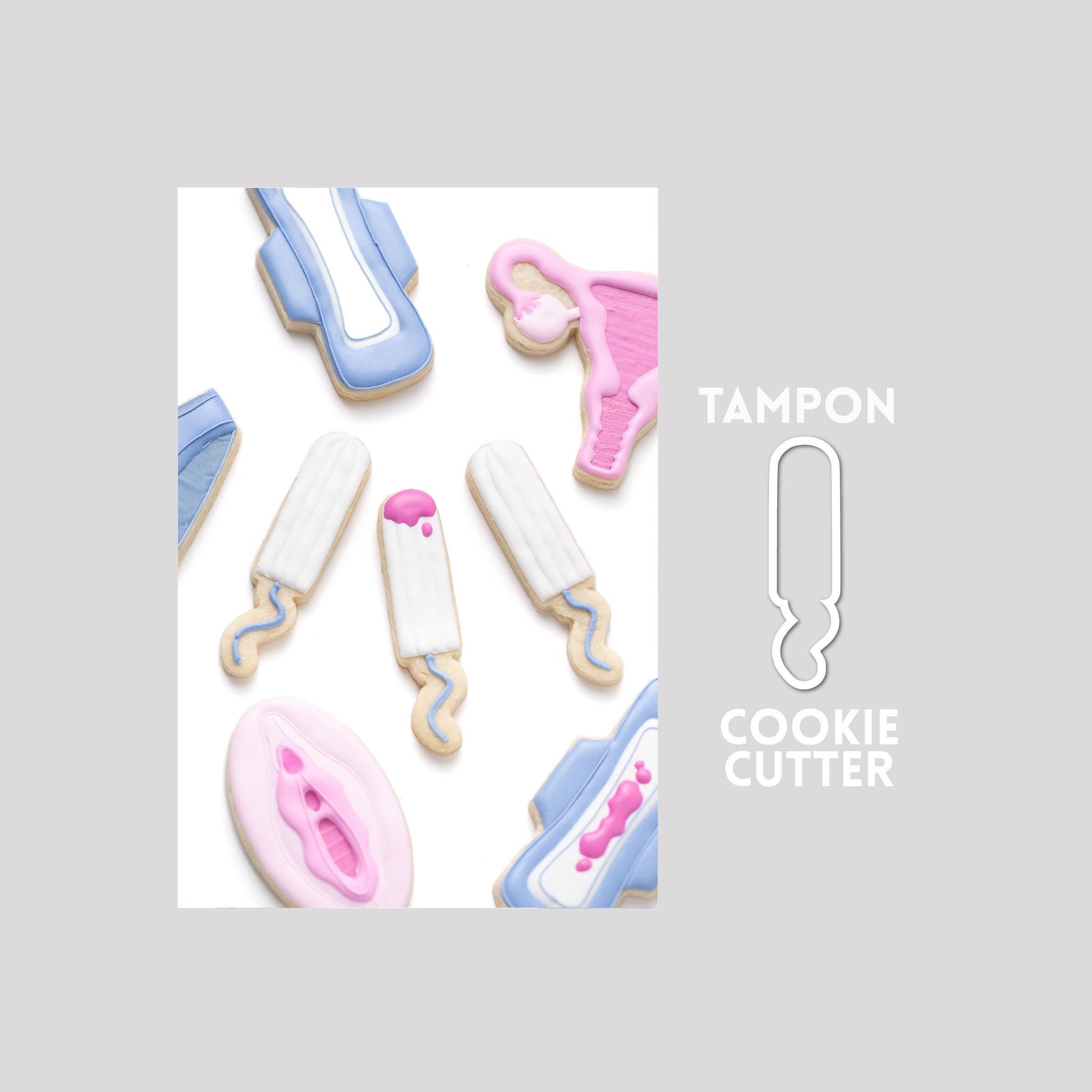 Decorated tampon sugar cookie next to a tampon cookie cutter outline on a gray background.
