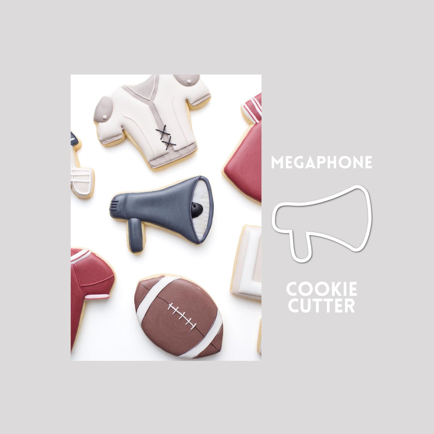 Decorated megaphone sugar cookie next to a megaphone cookie cutter outline on a gray background.