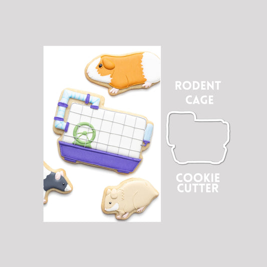 Decorated rodent cage sugar cookie next to a rodent cage cookie cutter outline on a gray background.