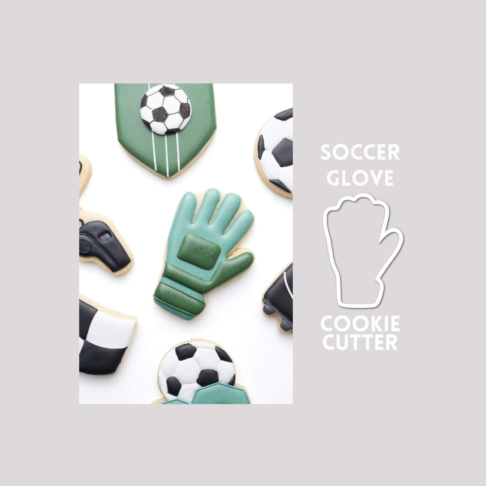 Decorated soccer glove sugar cookie next to a soccer glove cookie cutter outline on a gray background.