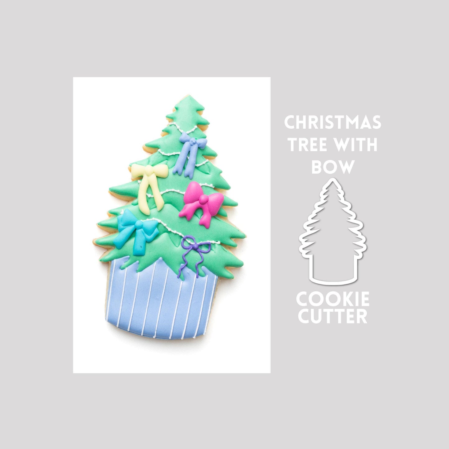 Decorated Christmas tree with bow sugar cookie next to a Christmas tree with bow cookie cutter outline on a gray background.