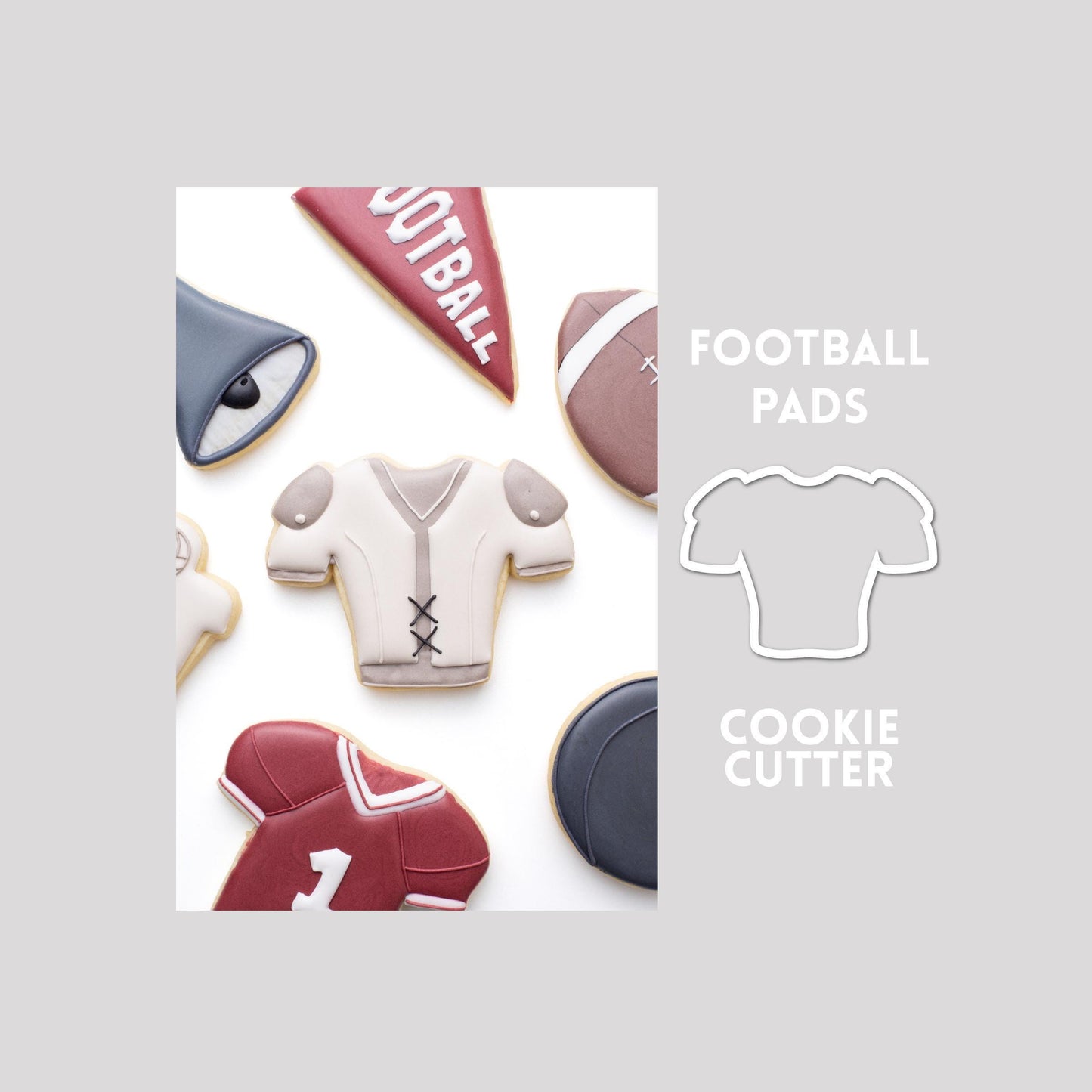 Decorated football pads sugar cookie next to a football pads cookie cutter outline on a gray background.