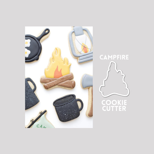 Decorated campfire sugar cookie next to a campfire cookie cutter outline on a gray background.