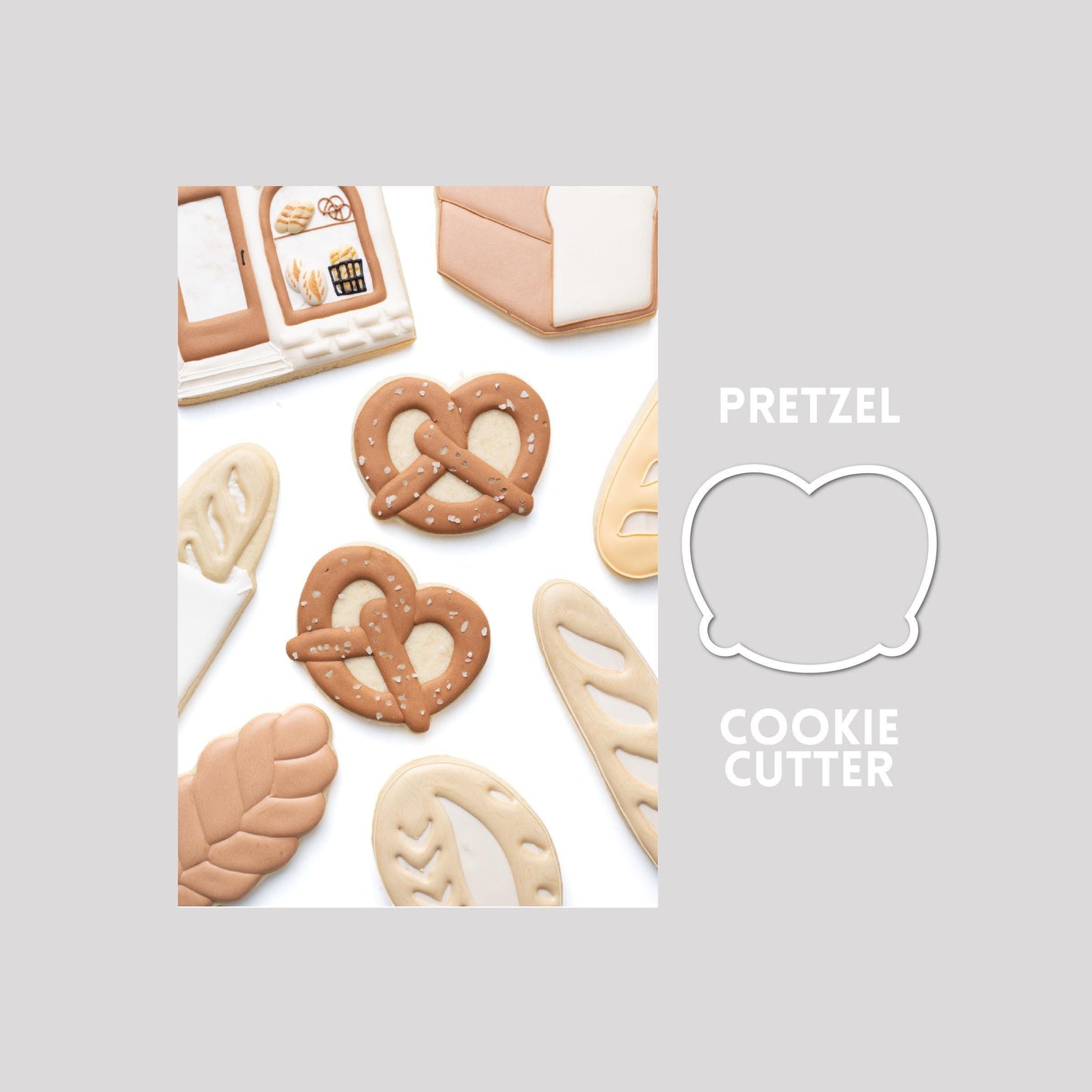 Decorated pretzel sugar cookie next to a pretzel cookie cutter outline on a gray background.