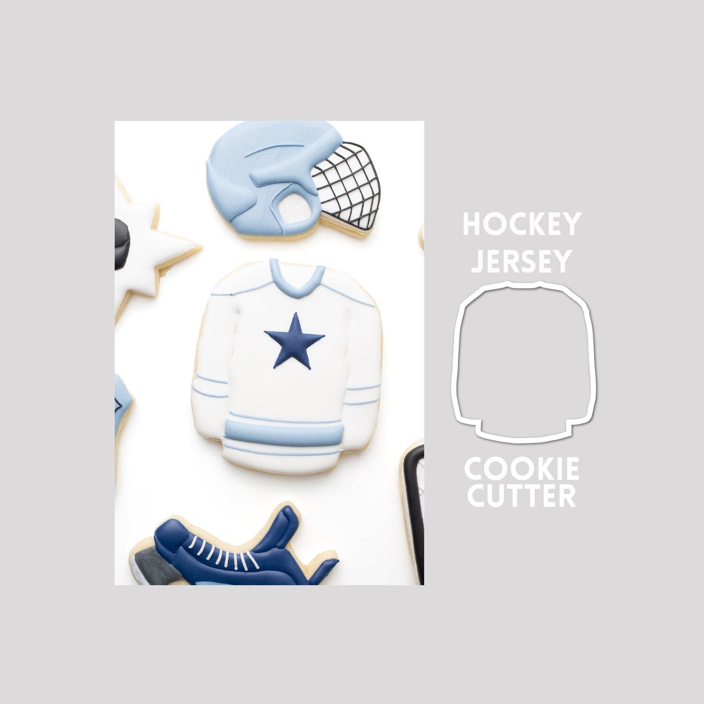 Decorated hockey jersey sugar cookie next to a hockey jersey cookie cutter outline on a gray background.
