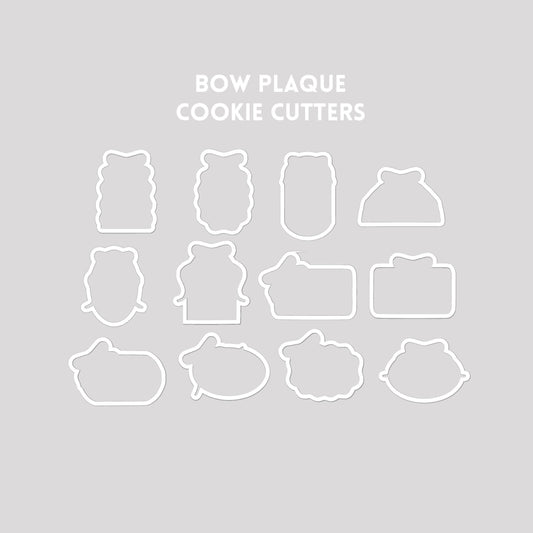Bow plaque shaped cookie cutter outlines on a gray background.