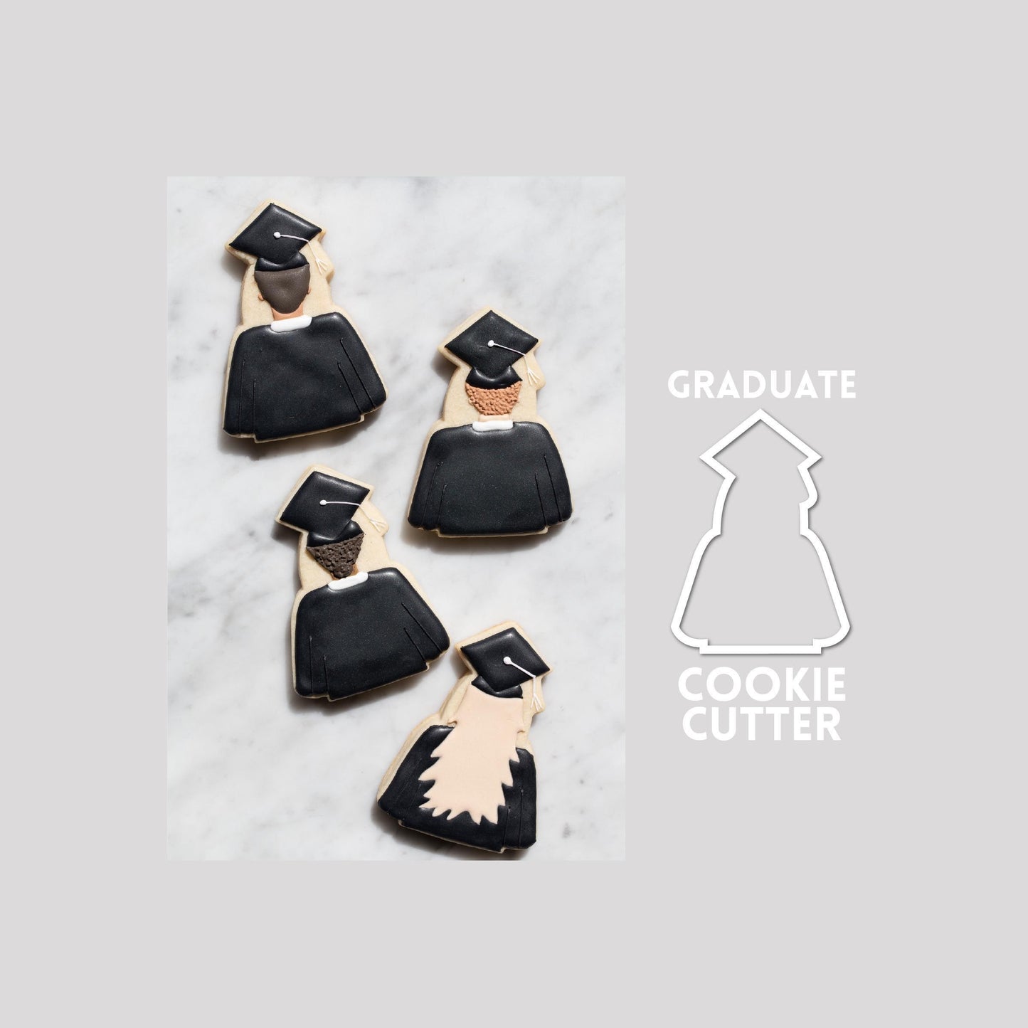 Decorated graduate sugar cookie next to a graduate cookie cutter outline on a gray background.