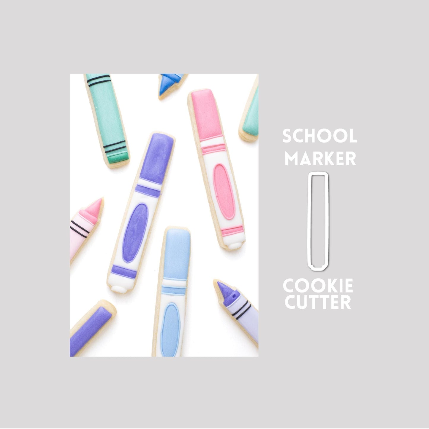 Decorated school marker sugar cookie next to a school marker cookie cutter outline on a gray background.