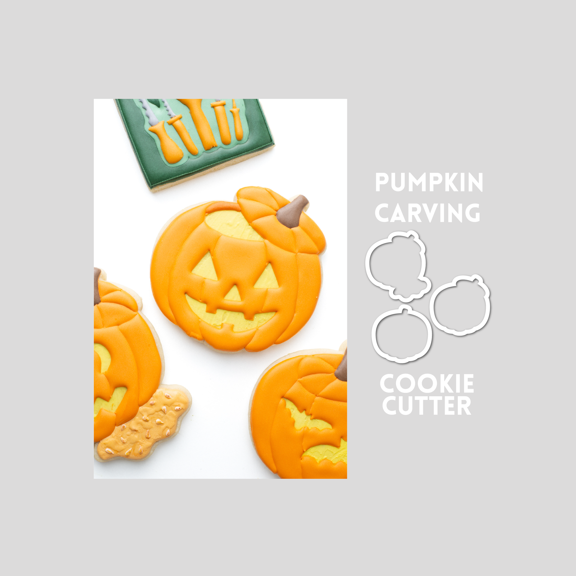 Decorated carved pumpkin sugar cookie next to a carved pumpkin cookie cutter outline on a gray background.