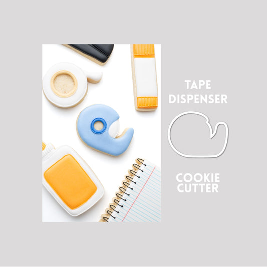 Decorated tape dispenser sugar cookie next to a tape dispenser cookie cutter outline on a gray background.